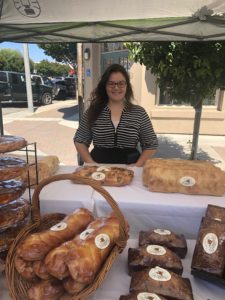 Heavenly Bakery employee Victoria selling baked goods at the bakery's booth, set up right in front of its building. Photo by Melissa Melton.