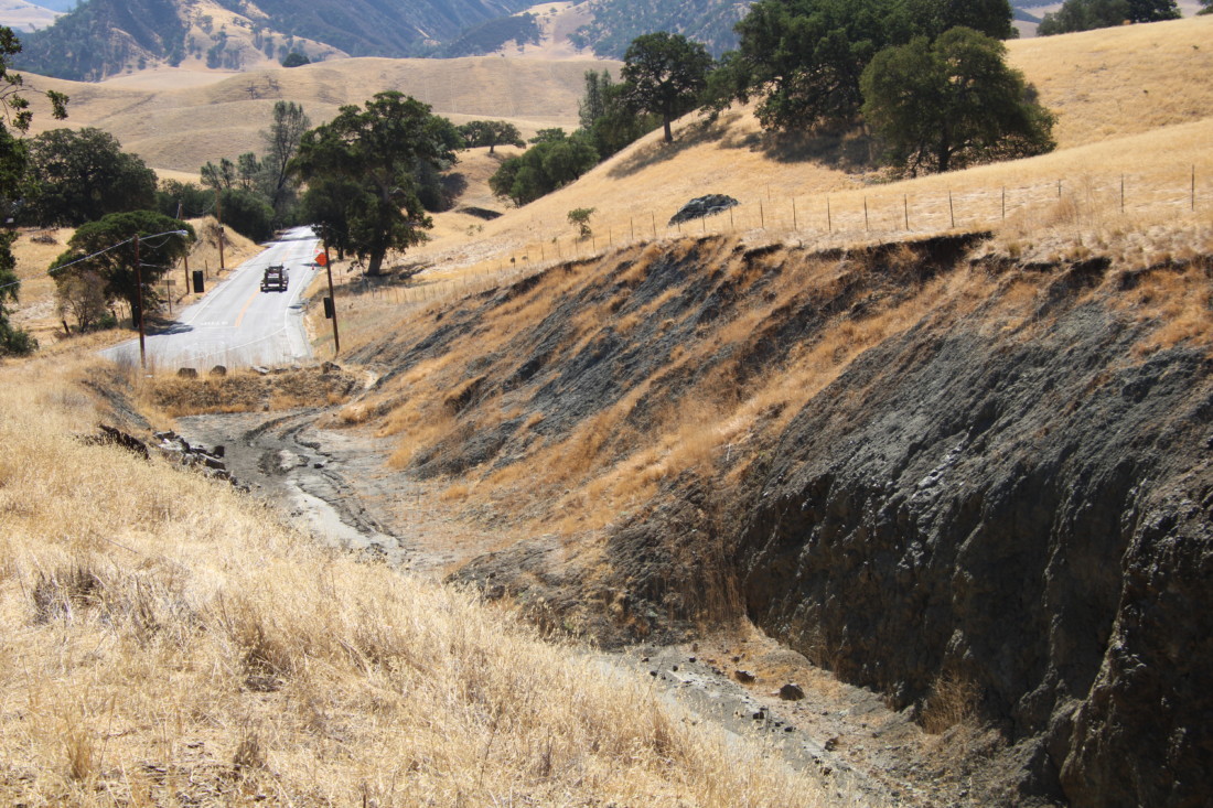 Looking down into the caved-in road.
