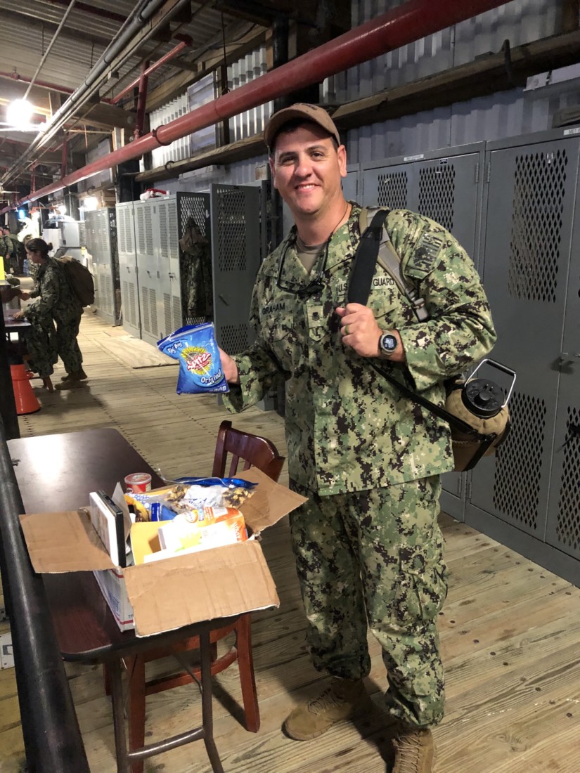 A Coast Guardsman receiving a care package from VFW 9242. Photo courtesy of Bernie Ramirez.