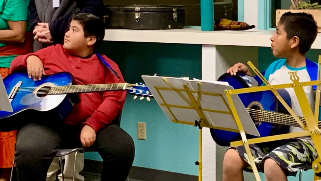 Eduardo Bueno and Juan Sanchez during the concert showcasing what they learned in the eight-week program. Photo by Juliana Luna.